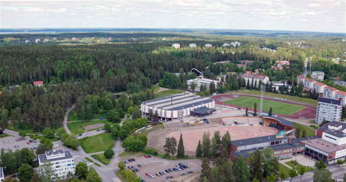 Ilmakuva Kouvolan keskustassa sijaitsevasta Urheilupuistosta, jossa ovat puisto, jäähalli, pesäpallostadion ja taustalla pilkottaa uimahalli.